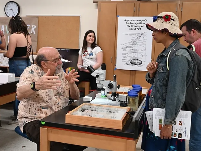 UC Davis forensic entomologist Robert "Bob" Kimsey answering questions at his "Dr. Death" booth in Briggs Hall during the 2023 UC Davis Picnic Day. (Photo by Kathy Keatley Garvey)