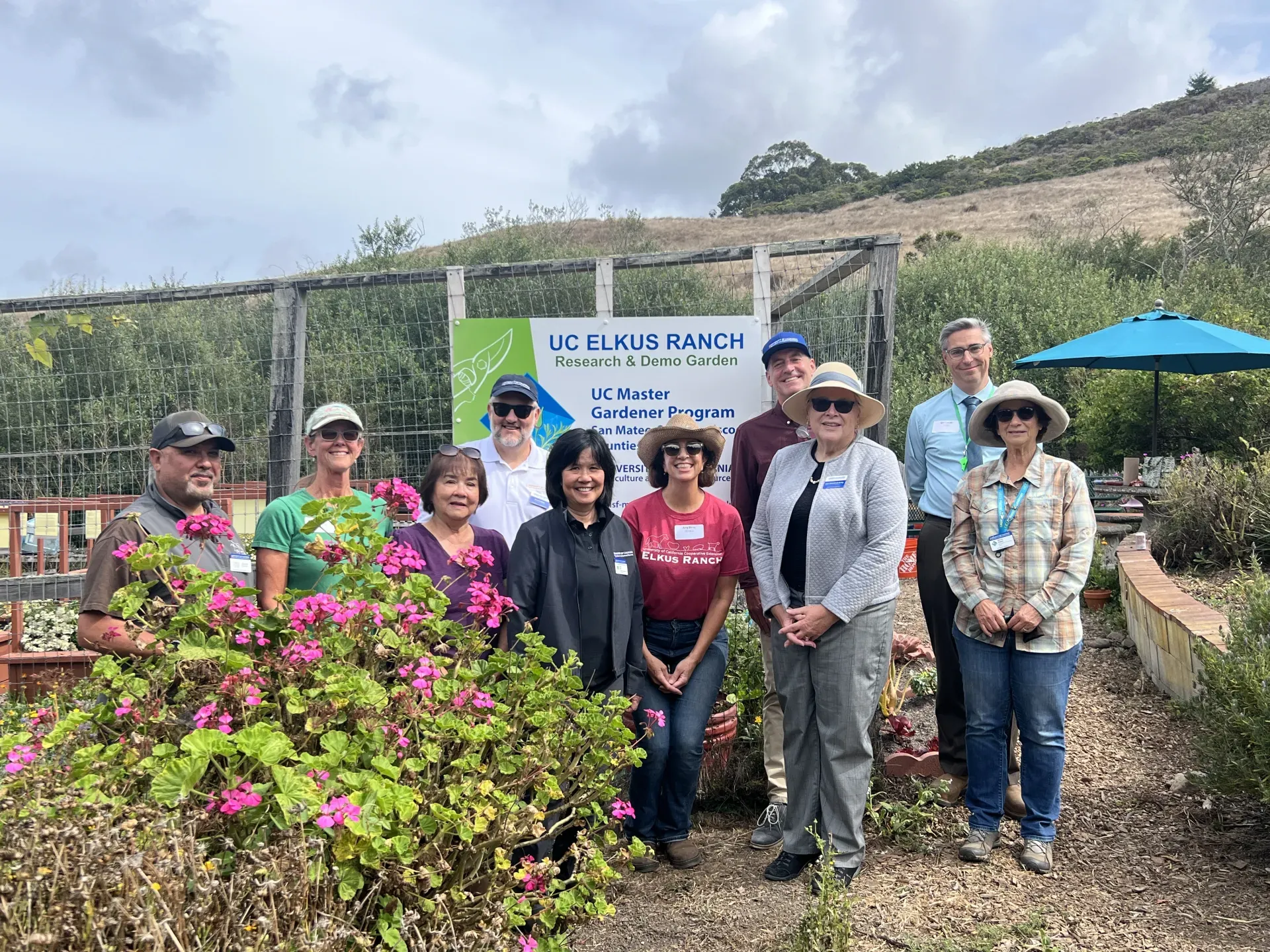 Ten people pose in a garden at Elkus Ranch