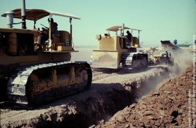Figure 8. Tandem D8H crawlers pulling a large slip plow to thoroughly mix a stratified soil near Santa Maria. The result has been described as a