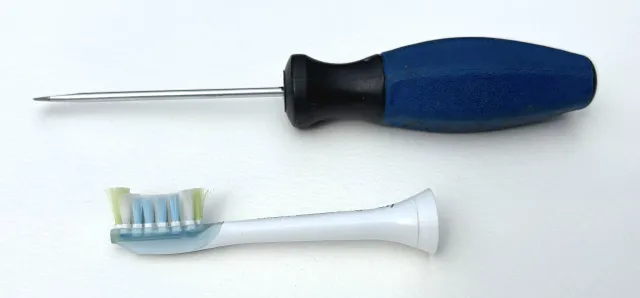 A screwdriver and an old toothbrush