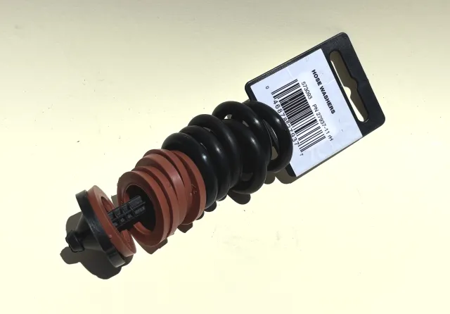 A set of hose gaskets and washers threaded on a plastic packaging tag.