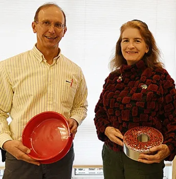 Proof of the pudding is in the results! Steve Nadler winner of the best non-chocolate cookie, and Sharon Lawler, winner of the best chocolate cookie, hold their empty containers. (Photo by Kathy Keatley Garvey)